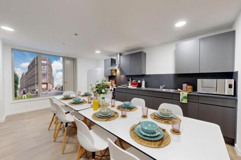 Modern kitchen featuring ample space for dining...