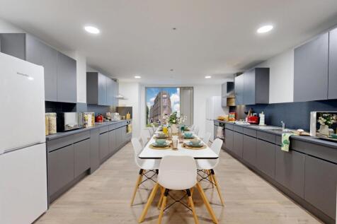 This modern kitchen features sleek cabinetry an...