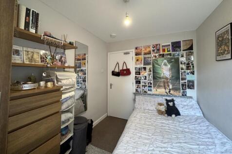 This inviting double bedroom features a cozy la...