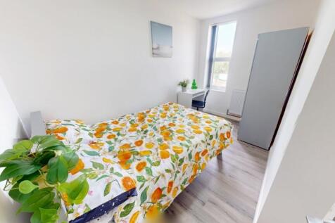 Bright and airy bedroom featuring a comfortable...
