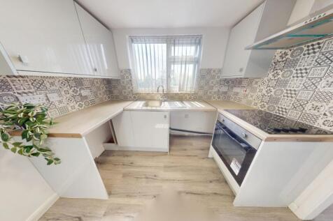 Bright and modern kitchen featuring a stylish t...