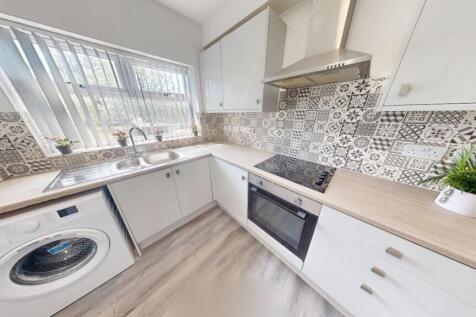 Bright and modern kitchen featuring stylish pat...