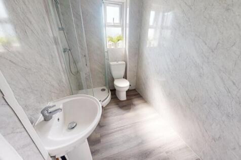 Bright and clean bathroom with modern grey tile...