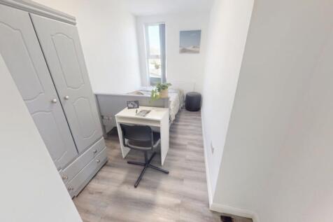 A bright and tidy single bedroom featuring a li...
