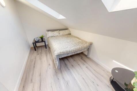 A clean and bright single bedroom featuring a c...