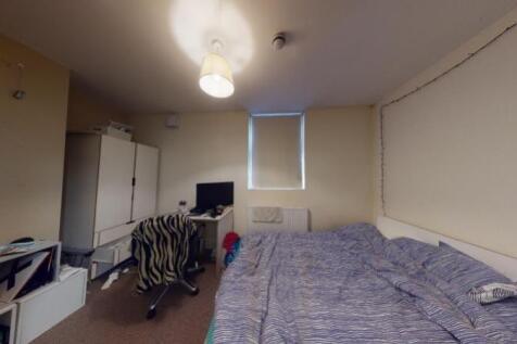A simple and tidy single bedroom featuring a be...