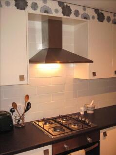 A modern kitchen featuring a sleek design with ...