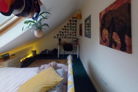 Bright and cozy master bedroom featuring a comf...