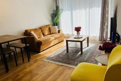 A bright and inviting living room featuring a c...