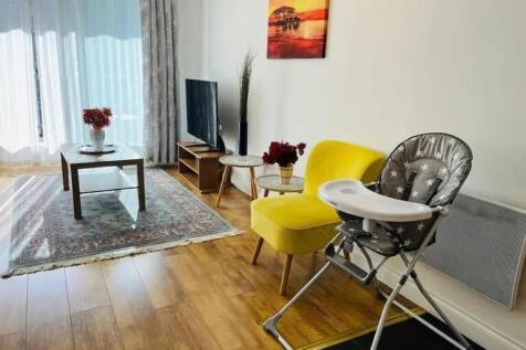 A bright and welcoming living room featuring wa...
