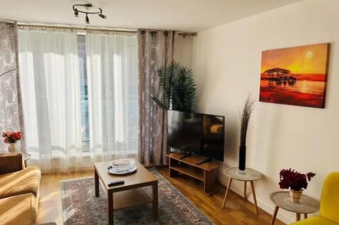Bright and inviting living room featuring large...