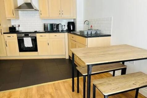 Bright and modern kitchen featuring light wood ...