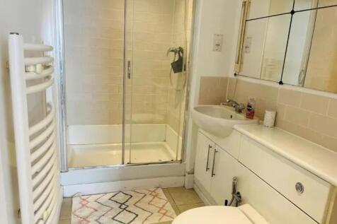 Bright and clean bathroom featuring a walk-in s...