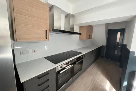 A modern and spacious kitchen featuring ample s...