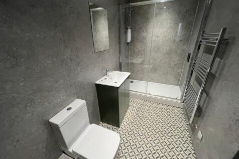 A modern and stylish bathroom featuring a spaci...