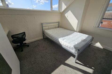 Bright and airy bedroom with large windows allo...