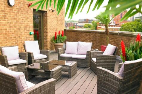 A stylish outdoor garden seating area with mode...