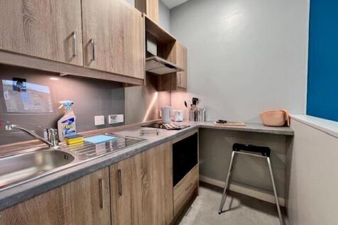 Modern kitchen with wooden cabinetry and integr...