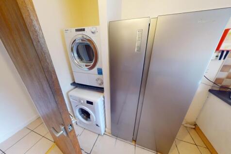 A compact and tidy kitchen area featuring moder...