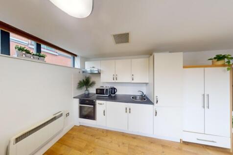Bright and modern kitchen featuring sleek white...