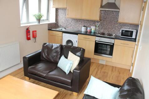 This modern kitchen area features sleek cabinet...