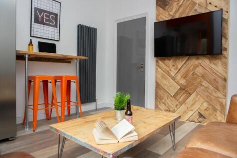 A modern living room featuring a stylish wooden...