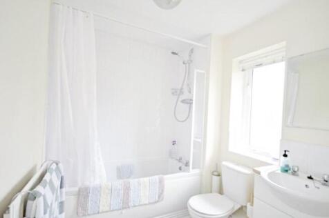 Bright, clean bathroom with a combined bath and...