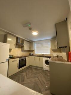 Modern kitchen with light cabinetry, integrated...