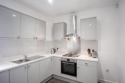 Modern kitchen equipped with sleek cabinetry an...
