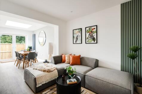 A spacious and modern living room filled with n...