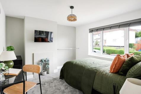 A stylish and inviting double bedroom with ampl...