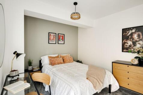 A stylish and inviting double bedroom featuring...
