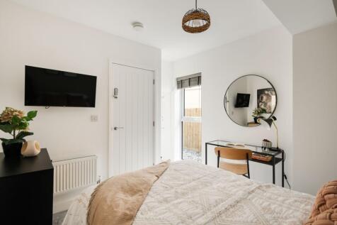 A bright and inviting double bedroom featuring ...