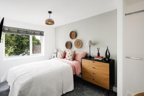 A bright and inviting double bedroom featuring ...