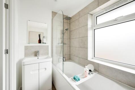 A modern and clean bathroom featuring a bath an...