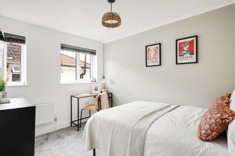 A bright and inviting double bedroom featuring ...