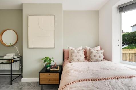 A stylish and well-lit double bedroom featuring...