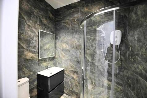 Modern bathroom featuring a sleek black vanity ...