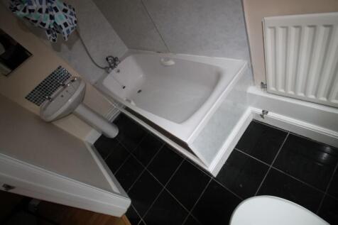 This well-designed bathroom features a spacious...