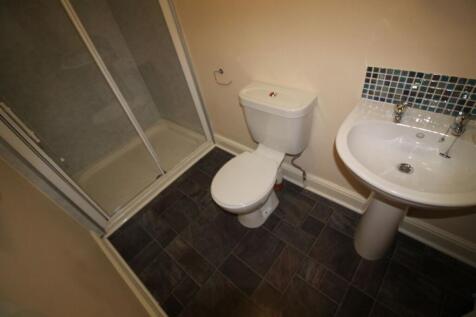 A modern bathroom featuring a sleek shower, sty...
