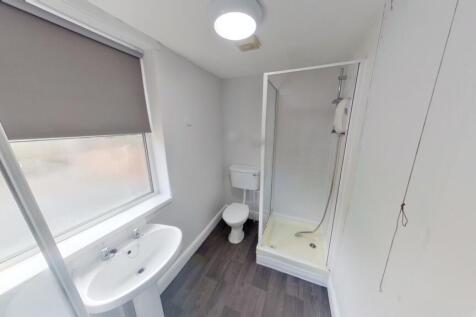 Bright and clean bathroom featuring a modern sh...