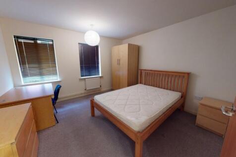 Bright and inviting master bedroom with a woode...
