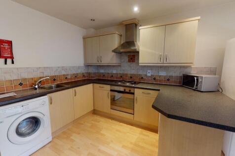 Bright and modern kitchen featuring ample cabin...