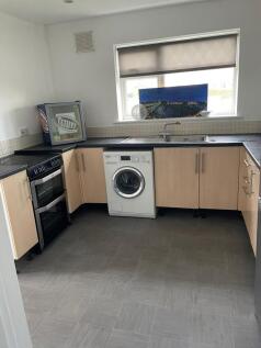 A tidy kitchen featuring essential appliances, ...