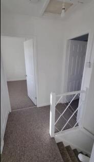 A clean and spacious hallway with ample natural...