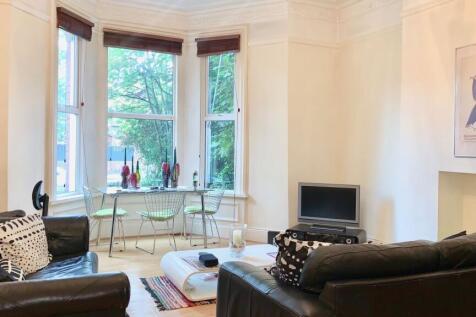 A bright and welcoming living room featuring la...