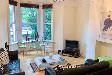 A bright and inviting living room featuring lar...