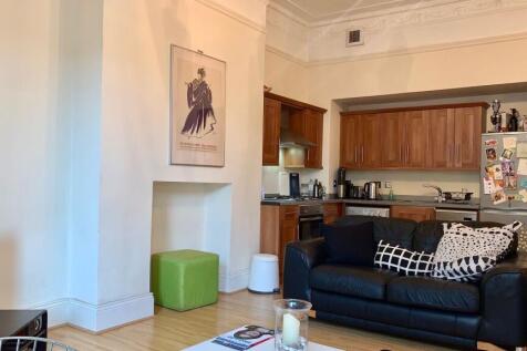 A cozy and stylish living room featuring a comf...