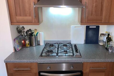 A neat and functional kitchen featuring a gas h...
