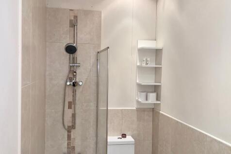 A modern bathroom featuring a walk-in shower wi...